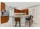 Well-appointed kitchen with dark wood cabinets, granite countertops, a center island, and modern appliances at 25946 Buckthorn Ave, Land O Lakes, FL 34639