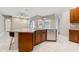 Kitchen island with granite countertops, a stainless steel dishwasher and breakfast bar seating at 25946 Buckthorn Ave, Land O Lakes, FL 34639
