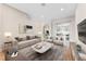 Staged living room with modern furniture, decorative accents, and sliding glass doors leading to the outdoors at 25946 Buckthorn Ave, Land O Lakes, FL 34639