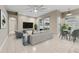 Comfortable living room with a large sofa, television, and adjoining dining area at 25946 Buckthorn Ave, Land O Lakes, FL 34639