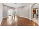 Spacious living area with hardwood floors, arched doorways, and ample natural light for comfortable living at 25946 Buckthorn Ave, Land O Lakes, FL 34639