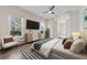 Bright main bedroom with ample natural light, a ceiling fan, and an ensuite bathroom at 25946 Buckthorn Ave, Land O Lakes, FL 34639