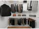 Organized walk-in closet with clothes, shelves, and wood floor, offering ample storage space at 25946 Buckthorn Ave, Land O Lakes, FL 34639