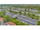 Picturesque aerial view of the community with lush greenery, a canal, and well-maintained townhomes at 267 Countryside Key Blvd, Oldsmar, FL 34677