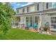 Enjoy the backyard with a patio, green grass, and furniture, perfect for outdoor relaxation and entertainment at 267 Countryside Key Blvd, Oldsmar, FL 34677