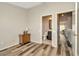 Bedroom with hardwood floors, bathroom and hallway access, and tan walls at 267 Countryside Key Blvd, Oldsmar, FL 34677