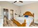 Spacious bedroom boasts a ceiling fan, wood floors, and ensuite bathroom access at 267 Countryside Key Blvd, Oldsmar, FL 34677
