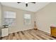 Bedroom showcasing wood floors, a ceiling fan, and natural light at 267 Countryside Key Blvd, Oldsmar, FL 34677