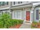 Close-up of a home's entry with a charming front door, and lush landscaping at 267 Countryside Key Blvd, Oldsmar, FL 34677