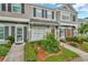 Lovely townhome with well-manicured landscaping and inviting walkway to the front door at 267 Countryside Key Blvd, Oldsmar, FL 34677