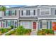 Charming townhome featuring a well-maintained exterior, landscaped yard, and inviting front entrance at 267 Countryside Key Blvd, Oldsmar, FL 34677