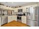 Modern kitchen featuring stainless steel appliances, granite countertops, and white cabinetry at 267 Countryside Key Blvd, Oldsmar, FL 34677