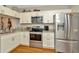 Modern kitchen featuring stainless steel appliances, granite countertops, and white cabinetry and island seating at 267 Countryside Key Blvd, Oldsmar, FL 34677