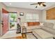 Inviting living room with a plush sectional, ceiling fan, and ample natural light at 267 Countryside Key Blvd, Oldsmar, FL 34677