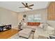 Inviting living room with a plush sectional, ceiling fan, and ample natural light at 267 Countryside Key Blvd, Oldsmar, FL 34677