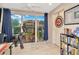 Well-lit home office with a view of the patio, complete with a ceiling fan, and custom décor at 267 Countryside Key Blvd, Oldsmar, FL 34677
