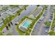 Aerial view of the community pool nestled between the buildings and canal, offering a refreshing escape at 267 Countryside Key Blvd, Oldsmar, FL 34677