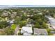 Aerial view of residential neighborhood featuring homes, mature trees and green lawns at 3108 S Omar Ave, Tampa, FL 33629
