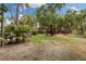 Lush backyard featuring a playset under a mature tree, perfect for children and outdoor activities at 3108 S Omar Ave, Tampa, FL 33629