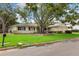 This single-story home offers a spacious front yard, mature trees, and a two-car garage at 3108 S Omar Ave, Tampa, FL 33629