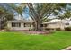 This single-story home has mature trees, a well-manicured lawn and a two-car garage at 3108 S Omar Ave, Tampa, FL 33629
