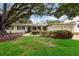 Desirable single-story home features a two-car garage, mature landscaping and white brick exterior at 3108 S Omar Ave, Tampa, FL 33629