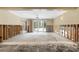 Partially renovated living room with white trim, flooded floors, and access to the backyard pool at 3108 S Omar Ave, Tampa, FL 33629