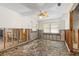 Partially renovated living room featuring a ceiling fan, two windows, and a neutral color palette at 3108 S Omar Ave, Tampa, FL 33629