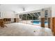 Bright living room with a view of the pool, and large glass doors ready to be remodeled at 3108 S Omar Ave, Tampa, FL 33629