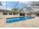 The backyard pool featuring a large outdoor deck and screened-in patio perfect for outdoor entertaining at 3108 S Omar Ave, Tampa, FL 33629