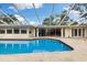 Inviting screened-in pool area featuring a large deck, perfect for outdoor relaxation and entertainment at 3108 S Omar Ave, Tampa, FL 33629