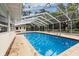 Inviting screened-in pool area featuring a large deck, perfect for outdoor relaxation and entertainment at 3108 S Omar Ave, Tampa, FL 33629