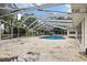 Inviting screened-in pool area featuring a large deck, perfect for outdoor relaxation and entertainment at 3108 S Omar Ave, Tampa, FL 33629