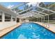 Inviting screened-in pool area featuring a large deck, perfect for outdoor relaxation and entertainment at 3108 S Omar Ave, Tampa, FL 33629