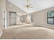 Bedroom featuring a ceiling fan, neutral paint, and large mirrored closet at 3269 Nicks Pl, Clearwater, FL 33761