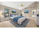 Staged bedroom featuring a ceiling fan, neutral paint, and modern decor at 3269 Nicks Pl, Clearwater, FL 33761