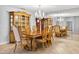 Elegant dining room with a large wooden table, chandelier, and mirrored wall at 3269 Nicks Pl, Clearwater, FL 33761