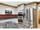 Modern kitchen featuring stainless steel appliances and a granite countertop island at 3269 Nicks Pl, Clearwater, FL 33761