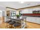 Kitchen with island seating, a brick fireplace, and views of the backyard at 3269 Nicks Pl, Clearwater, FL 33761