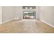 Bright and spacious living room featuring tile floors, high ceilings, and sliding glass doors to the patio and pool at 3269 Nicks Pl, Clearwater, FL 33761