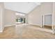 Bright and spacious living room featuring tile floors, high ceilings, and sliding glass doors to the patio and pool at 3269 Nicks Pl, Clearwater, FL 33761