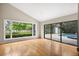 Bright living room features hardwood floors and view of pool at 3269 Nicks Pl, Clearwater, FL 33761