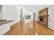 Bright living room with brick fireplace, hardwood floors, and large windows at 3269 Nicks Pl, Clearwater, FL 33761