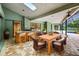 Inviting outdoor kitchen with bar seating, dining table and access to the pool area at 3269 Nicks Pl, Clearwater, FL 33761