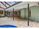 Expansive outdoor patio with seating, an outdoor kitchen and a view of the pool at 3269 Nicks Pl, Clearwater, FL 33761