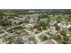 An aerial view showcases a neighborhood with mature trees, lush landscaping, and nearby lakes, highlighted by a location pin at 3501 Sarazen Dr, New Port Richey, FL 34655