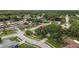 An aerial view of the neighborhood with lush tree cover over the homes, wide streets, and well-manicured lawns and sidewalks at 3501 Sarazen Dr, New Port Richey, FL 34655