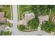 Birds eye view of a single Gathering residence with mature landscaping, and a screen lanai, with street views in the frame at 3501 Sarazen Dr, New Port Richey, FL 34655