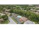 Aerial shot of community pool with ample parking and amenities, surrounded by lush trees and residential buildings at 3501 Sarazen Dr, New Port Richey, FL 34655