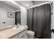 Bathroom featuring a vanity sink, toilet, and shower with a curtain at 3501 Sarazen Dr, New Port Richey, FL 34655